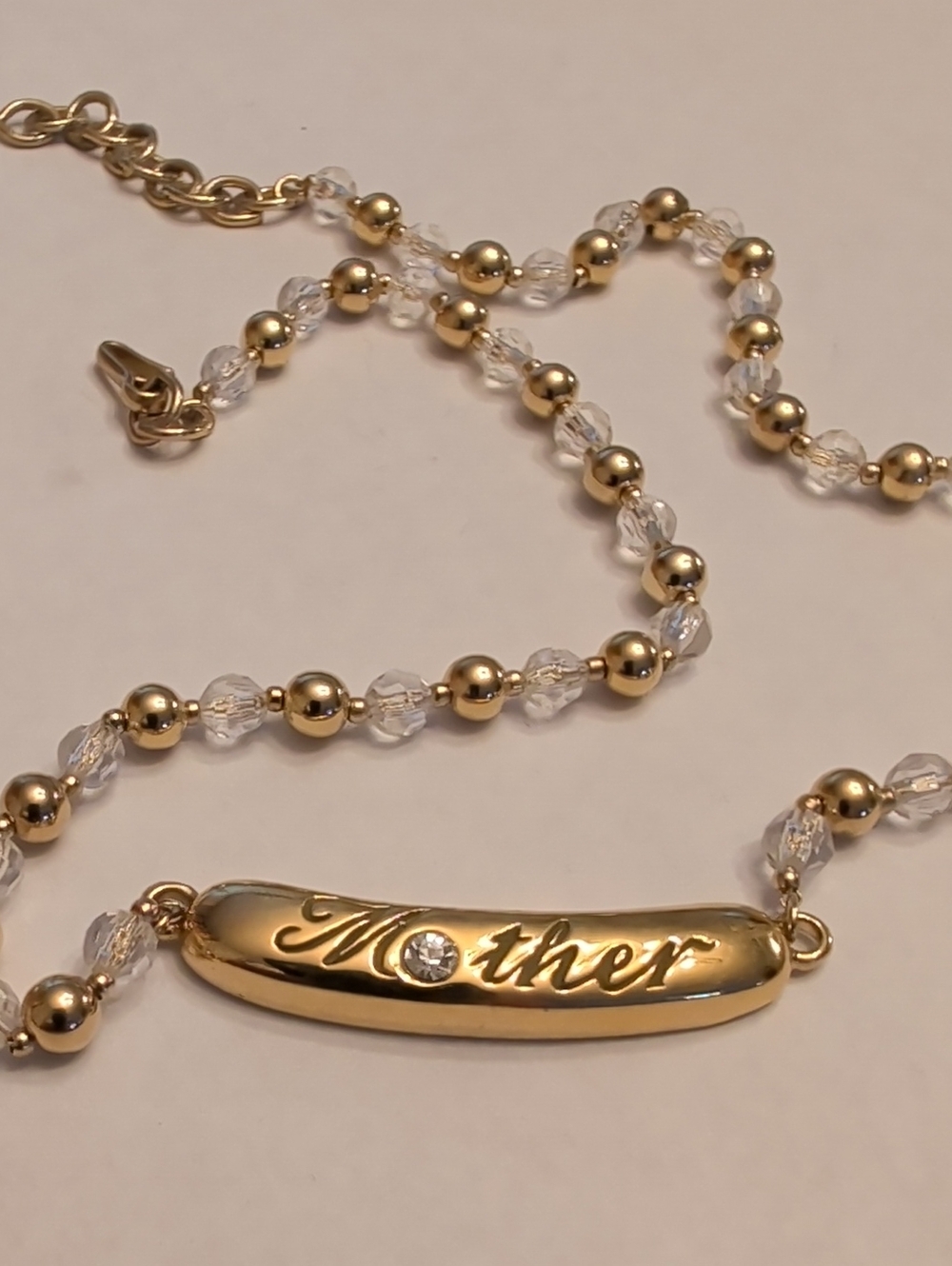 Monet Gold Tone Mother Pendant Necklace with Clear Beads